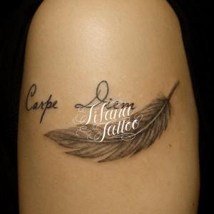 羽と文字のタトゥー